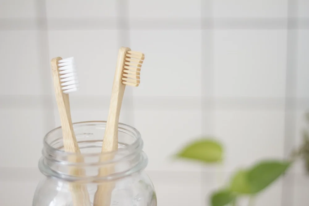 Toothbrushes in a jar. Photo by <a href='https://unsplash.com/@superkitina'>Superkitina</a> on <a href='https://unsplash.com/photos/rCT928GIboM'>Unsplash</a>